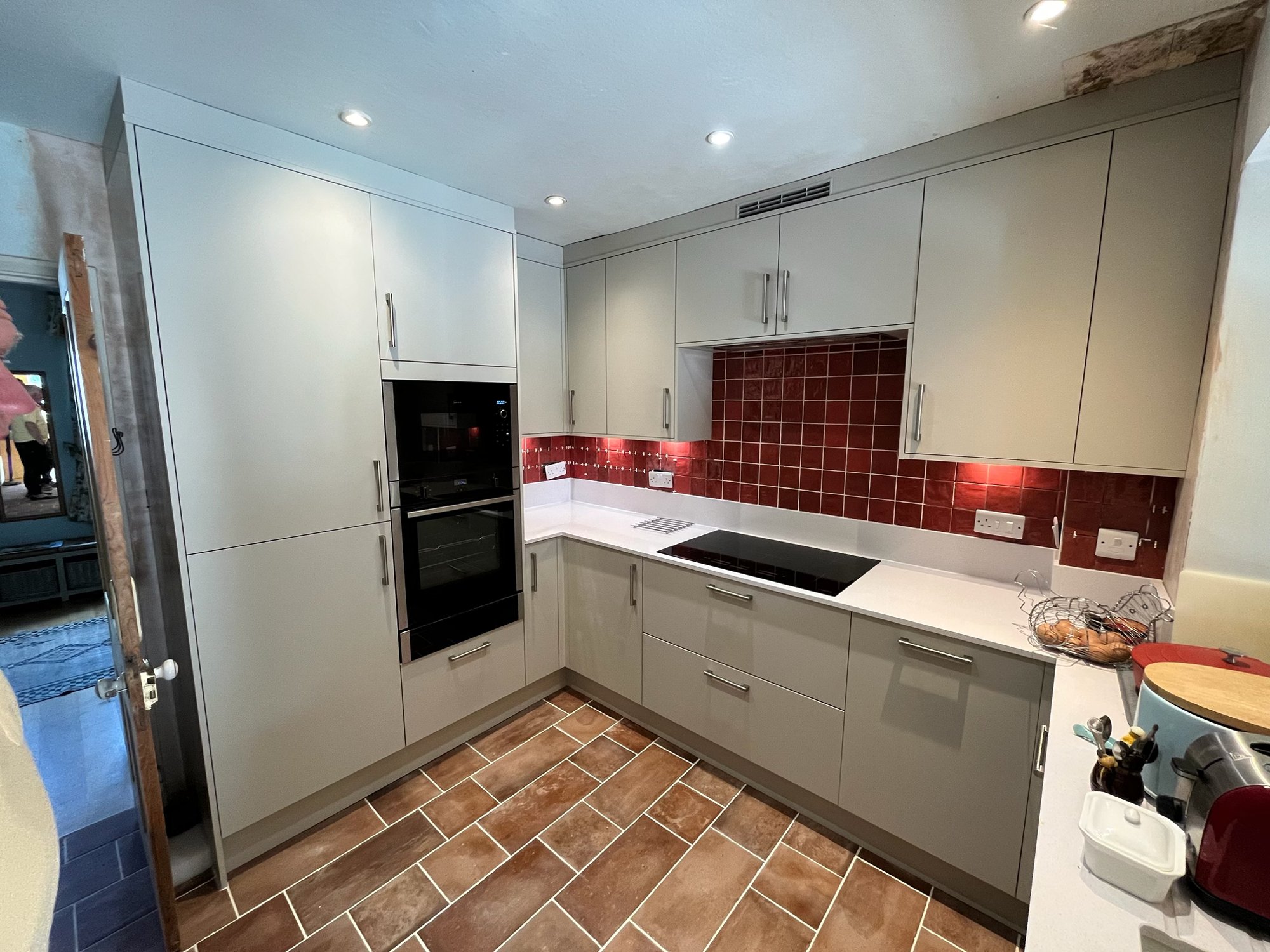 Stone Handleless Kitchen with Red Brick Splashback — Oxfordshire